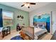 bedroom with custom mountain mural, natural wood bed frame, and blue shag rug at 2707 162Nd E Ave, Parrish, FL 34219