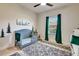 Cozy Bedroom featuring a gray crib, patterned rug, and charming forest-themed decor at 2707 162Nd E Ave, Parrish, FL 34219