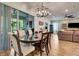 Dining room with a decorative chandelier, sliding glass doors, and views of the outdoors at 2707 162Nd E Ave, Parrish, FL 34219