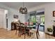 Cozy dining room featuring wood floors, an elegant chandelier, and sliding glass doors leading to the lanai at 2707 162Nd E Ave, Parrish, FL 34219