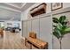 Inviting entryway with bench, woven baskets, paneled walls and wood-look tile leading to the spacious living area at 2707 162Nd E Ave, Parrish, FL 34219