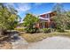 Two-story home with a front porch framed by lush landscaping and a walkway at 2707 162Nd E Ave, Parrish, FL 34219
