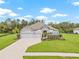 Beautiful single-story home with stone accents, a three-car garage, and lush landscaping at 2707 162Nd E Ave, Parrish, FL 34219