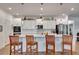 Stylish kitchen with white cabinetry, quartz countertops, stainless appliances, and bar seating at 2707 162Nd E Ave, Parrish, FL 34219