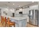 Bright kitchen with a large island, stainless steel appliances, pendant lighting, and white cabinetry at 2707 162Nd E Ave, Parrish, FL 34219
