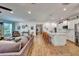 Open-concept living area featuring a kitchen island, dining space, and comfortable living room with ample natural light at 2707 162Nd E Ave, Parrish, FL 34219