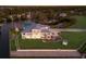 Waterfront estate featuring manicured lawn, mature palms, multiple balconies, and a large boat dock at 327 Riverpoint Ne Dr, Bradenton, FL 34208