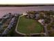 Expansive estate situated on oversized lot showcasing lawn, mature trees, and waterfront views at 327 Riverpoint Ne Dr, Bradenton, FL 34208