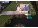 Aerial shot of waterfront home featuring manicured lawn, long driveway, and private boat dock at 327 Riverpoint Ne Dr, Bradenton, FL 34208