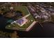 Waterfront estate boasts manicured lawns, private boat dock, and breathtaking water views from an aerial perspective at 327 Riverpoint Ne Dr, Bradenton, FL 34208