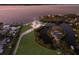 Aerial view showcases the waterfront property, lush landscaping, and boat dock in a tranquil setting at 327 Riverpoint Ne Dr, Bradenton, FL 34208