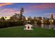 Backyard on the water features a charming dog house on a large well maintained lawn at 327 Riverpoint Ne Dr, Bradenton, FL 34208