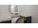 Stylish bathroom vanity featuring granite countertop, vessel sinks and a decorative round mirror at 327 Riverpoint Ne Dr, Bradenton, FL 34208