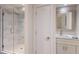 Modern bathroom featuring glass enclosed shower, marble tiling, custom vanity, and contemporary fixtures at 327 Riverpoint Ne Dr, Bradenton, FL 34208