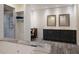 Bright bathroom with dual vanities, modern fixtures, and a spacious glass enclosed shower at 327 Riverpoint Ne Dr, Bradenton, FL 34208