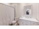 Bright bathroom featuring a white vanity, mirror, and a shower with a patterned curtain at 327 Riverpoint Ne Dr, Bradenton, FL 34208