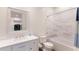 Bright bathroom with modern fixtures, white vanity, and shower and tub combination with tiled wall at 327 Riverpoint Ne Dr, Bradenton, FL 34208