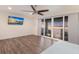 Bedroom featuring expansive sliding glass doors offering water views, and a wall-mounted television at 327 Riverpoint Ne Dr, Bradenton, FL 34208