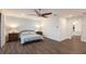 Comfortable bedroom featuring a ceiling fan, stylish wood flooring and light blue accent wall and matching bedding at 327 Riverpoint Ne Dr, Bradenton, FL 34208