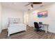 Cozy bedroom with a ceiling fan, a work desk, and stylish decor at 327 Riverpoint Ne Dr, Bradenton, FL 34208