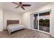 Contemporary bedroom with a ceiling fan, a platform bed, and sliding doors to the outdoors at 327 Riverpoint Ne Dr, Bradenton, FL 34208