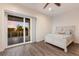 Bright bedroom with sliding glass doors opening to a balcony with scenic outdoor views at 327 Riverpoint Ne Dr, Bradenton, FL 34208