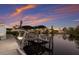Covered boat dock on waterfront with boat lift, cleaning station, and composite decking at 327 Riverpoint Ne Dr, Bradenton, FL 34208