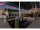 Boat dock and boat lift feature green metal roofing, composite decking, and decorative piling lights at 327 Riverpoint Ne Dr, Bradenton, FL 34208