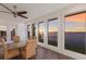 A dining area featuring water views, a modern ceiling fan, and seating for six at 327 Riverpoint Ne Dr, Bradenton, FL 34208