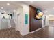 Inviting entryway with wood-look floors, wood slat wall, and contemporary beach artwork at 327 Riverpoint Ne Dr, Bradenton, FL 34208