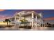 Stunning waterfront home elevated on stilts, with multiple balconies, ample parking, and lush tropical landscaping at 327 Riverpoint Ne Dr, Bradenton, FL 34208