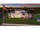 Stunning waterfront home boasting multi-level balconies, lush lawn, and picturesque sunset views at 327 Riverpoint Ne Dr, Bradenton, FL 34208