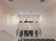 A modern foyer with a striking chandelier, glass railings, and plenty of natural light at 327 Riverpoint Ne Dr, Bradenton, FL 34208