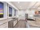 Modern kitchen with stainless steel appliances, granite countertops, and tiled backsplash with sink and windows at 327 Riverpoint Ne Dr, Bradenton, FL 34208