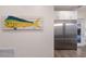 Kitchen showing stainless steel refrigerator and large mounted fish artwork nearby at 327 Riverpoint Ne Dr, Bradenton, FL 34208
