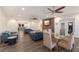 Spacious living room with hardwood floors, ceiling fans, and a modern TV at 327 Riverpoint Ne Dr, Bradenton, FL 34208