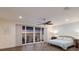 Inviting main bedroom with private balcony, ceiling fan, and water view at 327 Riverpoint Ne Dr, Bradenton, FL 34208