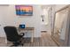 Office space featuring a work desk with a view into the bathroom and a TV at 327 Riverpoint Ne Dr, Bradenton, FL 34208