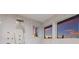 Modern shower featuring multiple shower heads and sunset views from the windows at 327 Riverpoint Ne Dr, Bradenton, FL 34208