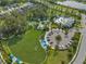The community features a pool, playground, sports field and gathering area with mature trees and green space at 3520 Woodmont Dr, Parrish, FL 34219