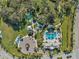 Aerial view of community pool, sports field, playground, park and gathering area with mature trees at 3520 Woodmont Dr, Parrish, FL 34219