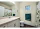 Comfortable bathroom with light walls, a sink, and a shower with decorative window at 3520 Woodmont Dr, Parrish, FL 34219