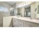 Modern bathroom featuring double sinks, a large mirror, and a shower with decorative window at 3520 Woodmont Dr, Parrish, FL 34219