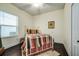 Cozy bedroom featuring natural light from a window, neutral walls, and hardwood floors at 3520 Woodmont Dr, Parrish, FL 34219