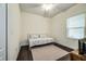 Minimalist bedroom with a neutral color palette, light walls, and hardwood floors at 3520 Woodmont Dr, Parrish, FL 34219