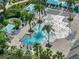 The community pool features tables and seating and is surrounded by lush, tropical plants at 3520 Woodmont Dr, Parrish, FL 34219