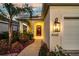 Close-up view of the front entrance, featuring a well-lit porch and decorative landscaping at 3520 Woodmont Dr, Parrish, FL 34219