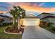 Charming single-story home with a well-maintained lawn, lush landscaping, and a two-car garage at 3520 Woodmont Dr, Parrish, FL 34219