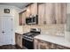 Kitchen featuring wood cabinetry, stainless steel appliances, and marbled countertops at 3520 Woodmont Dr, Parrish, FL 34219