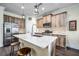 Kitchen featuring wood cabinetry, a stainless steel refrigerator, and barstool seating at 3520 Woodmont Dr, Parrish, FL 34219